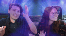 a man and a woman are sitting next to each other and smiling