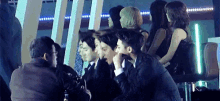 a group of people are sitting in a row in a room .