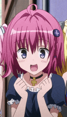 a girl with pink hair and a cross necklace