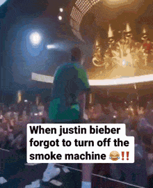 a blurry picture of a man on stage with the caption when justin bieber forgot to turn off the smoke machine !