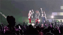 a group of people are performing on stage in front of a crowd of people