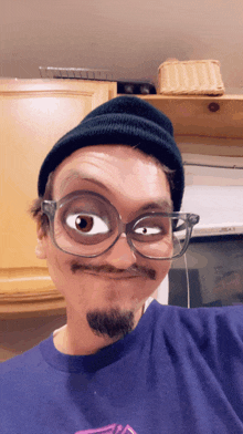 a man wearing glasses and a beanie makes a face