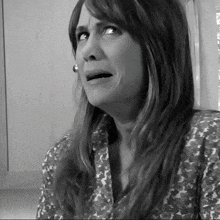 a black and white photo of a woman making a face