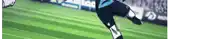 a soccer player is kicking a ball on a soccer field .