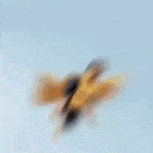 a blurry picture of a man in a yellow and black superhero costume flying through the air .