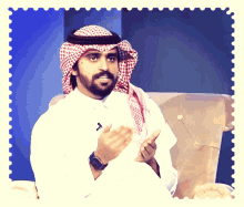 a man with a beard wearing a scarf and a watch