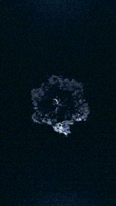 a close up of a circle of water with a black background