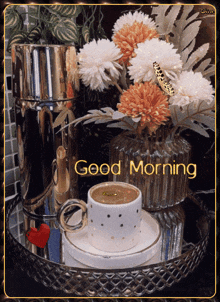 a cup of coffee and a vase of flowers with the words good morning