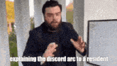 a man with a beard is explaining the discord arc to a resident in front of a whiteboard .