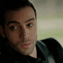 a close up of a man 's face with his mouth open