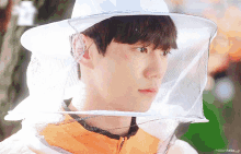 a close up of a person wearing a beekeeper 's hat with the word favorite below it