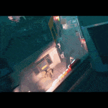 an aerial view of a city at night with a yellow sign that says ' subway ' on it