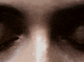 a close up of a person 's eyes with a white stripe on the nose