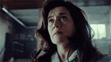 a close up of a woman 's face with a tear running down her cheek
