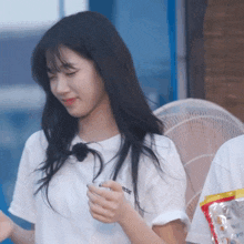 a woman wearing a white t-shirt that says rse on it