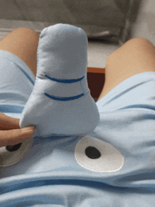 a person is holding a stuffed animal that looks like an elephant 's nose