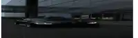a black sports car is parked in front of a building at night