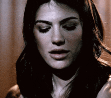 a close up of a woman 's face with the eyes closed