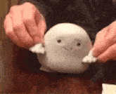 a person is playing with a stuffed animal that looks like a ghost .