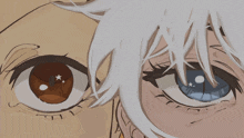 a close up of a person 's eyes with one being brown and the other being blue