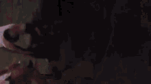a blurry picture of a woman dancing in a dark room .