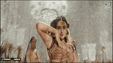 a woman in a red and gold dress with the words pranay_varma below her