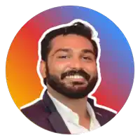 a man with a beard is smiling and wearing a suit