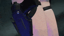 a person is holding a gun in a holster on their thigh .