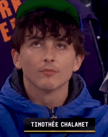a close up of timothee chalamet wearing a green hat