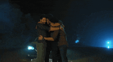 three men are hugging each other in front of a bmw