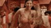 a woman in a red bra is dancing in front of a crowd of people .