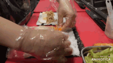 a person is making a sushi roll with the words made in animotica on the bottom right