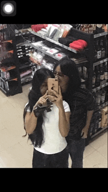 a woman is taking a picture of herself with her phone