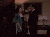 a man and woman hugging in front of a picture