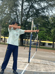 a man holding a bow and arrow with a shirt that says ' i love thailand ' on the front