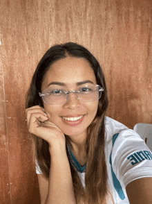 a woman wearing glasses and a shirt that says eagle