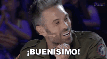 a man in a military uniform is laughing and says buenisimo
