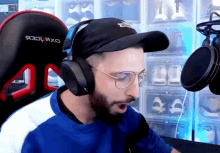a man is wearing headphones and a hat that says dxracer on it
