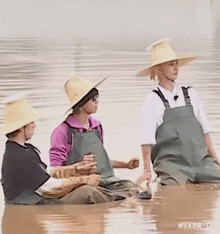 a group of people wearing hats and aprons are sitting in a boat in the water .