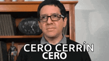 a man wearing glasses is standing in front of a bookshelf and a clock and says cero cerrin cero