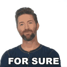 a man with a beard is smiling in front of a white background that says for sure
