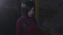 a woman is standing in a dark room wearing a red turtleneck and a black belt .