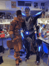 a man in a futuristic costume stands next to another man