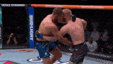 two men are fighting in a boxing ring with a bud light advertisement in the background
