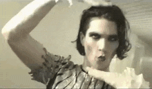 a woman in a silver dress is making a funny face .