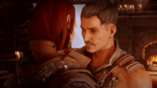 a man with a mustache and a woman with red hair are hugging