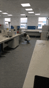 a woman kneeling down in a lab with a bottle of water