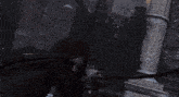 a woman in a black jacket is holding a sword in the snow
