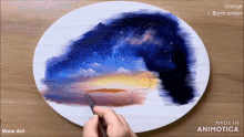 a painting is being painted on a white plate with the words wow art on the bottom right