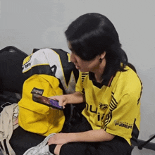 a person wearing a yellow jersey that says fiber